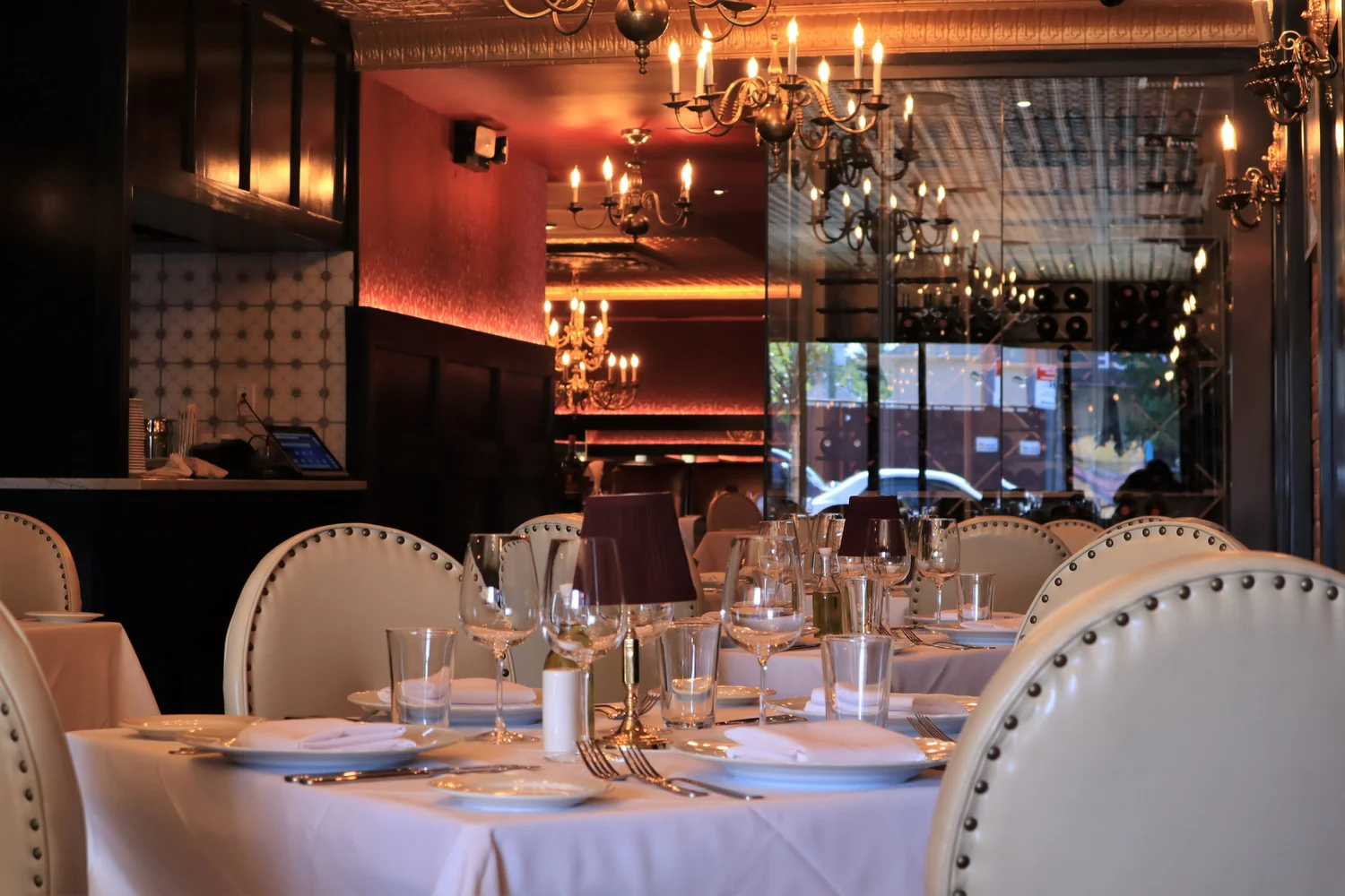 Dining room at Don Cheech with chandeliers and set tables